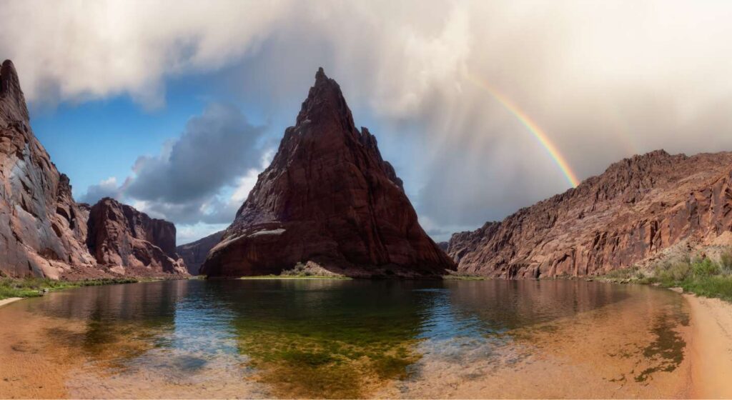 A rainbow over the water and mountains